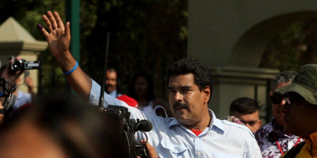 CARACAS, VENEZUELA - APRIL 14: Nicolas Maduro, candidate of PSUV greets the people after vote on April 14, 2013 in Caracas, Venezuela. (Photo by Amanda Perobelli/Brazil Photo Press/LatinContent/Getty Images)