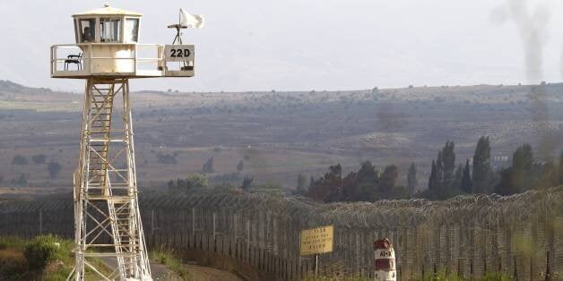 A UN peacekeeper keeps watch from an observation tower near the Quneitra crossing in the demilitarized United Nations Disengagement Observer Force (UNDOF) zone, in the Golan Heights on the ceasefire line between Syria and Israel, on July 18, 2013. Israel, which remains technically at war with Syria, seized 1,200 square kilometres (460 square miles) of the strategic plateau during the 1967 Six-Day War, which it later annexed in a move never recognised by the international community. AFP PHOTO / JACK GUEZ (Photo credit should read JACK GUEZ/AFP/Getty Images)