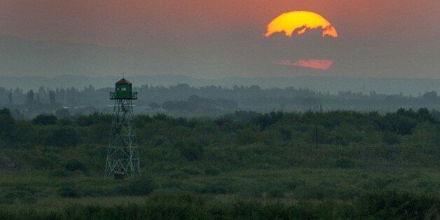The sun sets down over the border between Armenia and Turkey not far from the village of Khor Virap, some 50 kms from Yerevan on August 24, 2013. AFP PHOTO / STR (Photo credit should read STRINGER/AFP/Getty Images)