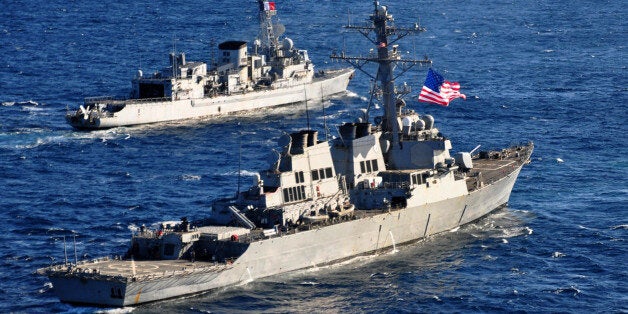 AT SEA - FEBRUARY 26, 2013: In this handout released by the U.S. Navy, the U.S. Navy guided-missile destroyer USS Barry (DDG 52) (foreground) pulls into formation with the French Marine Nationale anti-submarine frigate Jean de Vienne (D 643) during exercise Proud Manta 2013 in the Ionian Sea on February 26, 2013 at sea. In a response to a alleged chemical weapons attack on its own people by the Syrian regime the USS Mahan, the USS Barry, the USS Ramage, and the USS Gravely, all Arleigh Burke-class destroyers carrying Tomahawk land-attack missiles, are en route or in position in the eastern Mediterranean for a possible strike on Syrian military assets on August 28, 2013. (Photo by U.S. Navy via Getty Images)