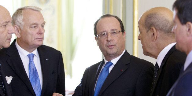 France's President Francois Hollande (C) speaks with (fromL) French Foreign minister Laurent Fabius, Prime minister Jean-Marc Ayrault, Defense minister Jean-Yves Le Drian and Interior minister Manuel Valls on August 28, 2013 at the Elysee palace in Paris. Hollande upped the ante on Syria on August 27, 2013 pledging to 'punish' the regime over suspected chemical attacks and boost military support for the opposition. The French Parliament will hold an emergency session to debate the Syria crisis on September 4, minister Alain Vidalies said today. The announced debate comes as France and its allies weigh a potential military intervention in Syria following an alleged chemical weapons attack last week in the Damascus suburbs that the West blames on the regime. AFP PHOTO / POOL / KENZO TRIBOUILLARD (Photo credit should read KENZO TRIBOUILLARD/AFP/Getty Images)