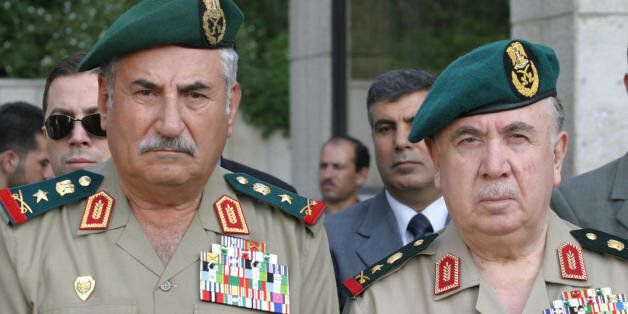 DAMASCUS, SYRIA: Syrian Defence Minister Hassan Turkmani (R) and Chief of Syrian Army Ali Habib wait outside the Al-Shami hospital in Damascus as the body of Syrian Interior Minister Lieutenant General Ghazi Kanaan, who committed suicide in his office yesterday, is carried into an ambulance, 13 October 2005. The former security chief for two decades in Lebanon is to be buried in his home village Bhamra, near Latakia in northwestern Syria. Kanaan shot himself in the mouth with his pistol, public prosecutor Mohammed Marwan al-Luwaji told the state news agency SANA. AFP PHOTO/LOUAI BESHARA (Photo credit should read LOUAI BESHARA/AFP/Getty Images)