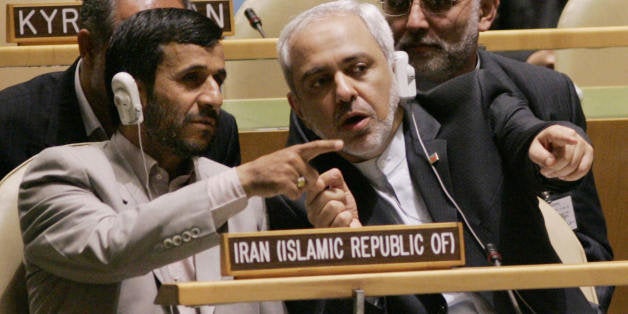 UNITED NATIONS, UNITED NATIONS: Iranian President Mahmoud Ahmadinejad (L) confers with Javad Zarif (R), Iran's United Nations ambassador, during the United Nations General Assembly 19 September 2006 at UN headquarters in New York. AFP PHOTO/Stan HONDA (Photo credit should read STAN HONDA/AFP/Getty Images)