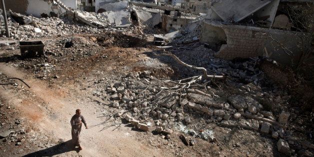 A man walks through a destroyed residential area of the Syrian city of Saraqib, southwest of Aleppo, on September 9, 2013, following repeated airstrikes by government forces' fighter jets. US President Barack Obama and his Russian counterpart Vladimir Putin discussed the idea of placing Syrian chemical weapons under international control at last week's G20 summit in Saint Petersburg, Putin's spokesman said on September 10, 2013. AFP PHOTO / GIOVANNI DIFFIDENTI (Photo credit should read GIOVANNI DIFFIDENTI/AFP/Getty Images)