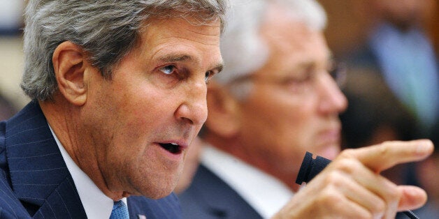 US Secretary of State John Kerry (L) speaks as US Defense Secretary Chuck Hagel (R) watches while testifying on Syria to the House Armed Services Committee on September 10, 2013 in the Rayburn House Office Building on Capitol Hill in Washington, DC. AFP PHOTO/Mandel NGAN (Photo credit should read MANDEL NGAN/AFP/Getty Images)