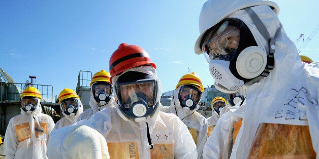 OKUMA, JAPAN - AUGUST 26: Japan Trade Minister Toshimitsu Motegi in protective suit checks the situation of halting contaminated groundwater around the No. 1 and No. 2 reactors along the sea during his visit to Fukushima Dai-ichi Nuclear Power Plant on August 26, 2013 in Okuma, Japan. Motegi pledged on Aug. 26 an urgent government action to curb leaks of radioactive water from the crippled Fukushima No. 1 nuclear power plant. (Photo by The Asahi Shimbun/The Asahi Shimbun via Getty Images)