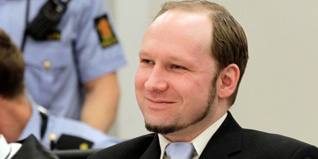 Mass killer Anders Behring Breivik smiles during his trial in room 250 of Oslo's central court on June 21, 2012. The trial of Anders Behring Breivik, who killed 77 people in Norway last July, enters the final stretch with the prosecutors' call for him to be sent either to prison or to a psychiatric ward. Prosecutors Svein Holden and Inga Bejer Engh are to begin presenting their much-awaited closing arguments at 1000 GMT, at the end of which they will reveal whether they want the court to find Breivik responsible or not for his actions. AFP PHOTO / SCANPIX/ROALD BERIT (Photo credit should read ROALD BERIT/AFP/GettyImages)