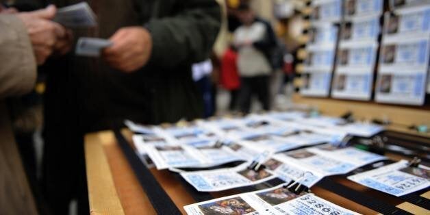 TO GO WITH AFP STORY BY DANIEL SILVA 'Christmas-Spain-finance-economy-lottery' A man buys ticket for the annual Christmas lot