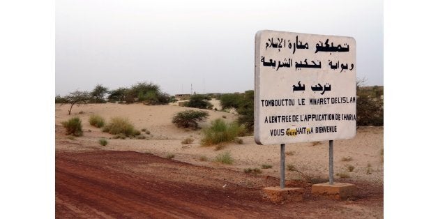 This picture on July 26, 2013 shows an old sign reading 'Timbuktu the minaret of islam, at the entrance of the sharia rule, w