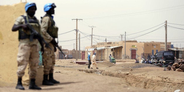 United Nations (UN) soldiers patrol on July 27, 2013 in the northern Malian city of Kidal. Clashes between Tuaregs and black Africans a week ago left four people dead while five polling officials were kidnapped in Tessalit, 200 kilometres (125 miles) north of Kidal, by gunmen thought to be from the MNLA. Millions of Malians are expected to vote Sunday in 'imperfect' elections they hope will usher in a new dawn of peace and stability in a country torn apart by an 18-month political crisis and armed conflict. Voters will have a choice of 27 candidates as they go to the polls for the first time since a separatist uprising led to a coup and then a sweeping Islamist offensive last year which upended one of the region's most stable democracies. AFP PHOTO / KENZO TRIBOUILLARD (Photo credit should read KENZO TRIBOUILLARD/AFP/Getty Images)