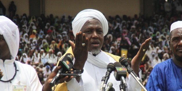 Mahmoud Dicko (C), head of Mali's High Islamic Council prays on August 12, 2012 in Bamako during a giant peace rally in Mali. Up to 60,000 people gathered Sunday for a giant peace rally in Mali, a country split in two after Islamists wrested control of northern desert regions after a March coup in the capital Bamako. The meeting for 'national peace and reconciliation' in Bamako's main stadium was called by the country's top Muslim body and drew several key politicians including Prime Minister Cheikh Modibo Diarra. AFP PHOTO / HABIBOU KOUYATE (Photo credit should read HABIBOU KOUYATE/AFP/GettyImages)