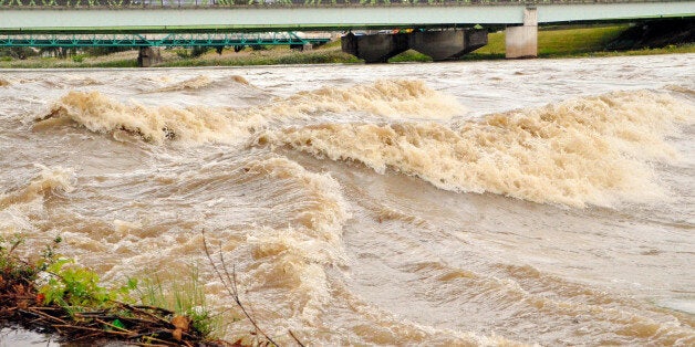 FUKUSHIMA, JAPAN - OCTOBER 16: (CHINA OUT, SOUTH KOREA OUT) Swollen Abukuma River due to the heavy rain triggered by Typhoon Wipha approaching, is seen on October 16, 2013 in Fukushima, Japan. Typhoon Wipha, or Typhoon No. 26, said to be the most powerful to ravage the Kanto region in a decade, deluged Izu Oshima Island, south of Tokyo with rainfall more than double the monthly average, leaving at least 16 people dead and about 50 others missing. (Photo by The Asahi Shimbun via Getty Images)