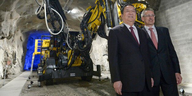 Yu Zhengsheng (L), current chairman of the Chinese People's Political Consultative Conference (CPPCC National Committee), poses with Atlas Copco AB Chief Executive Ronnie Leten in front of a mining drill during a visit to the industrial company Atlas Copco in Stockholm on June 3, 2013. AFP PHOTO / JANERIK HENRIKSSON / SCANPIX SWEDEN / SWEDEN OUT (Photo credit should read JANERIK HENRIKSSON/AFP/Getty Images)