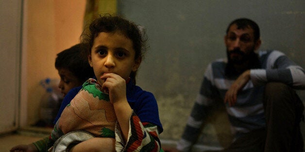 BEIRUT, LEBANON - NOVEMBER 09: Six-year-old Gazal pauses in a home she shares with 14 other Syrian refugees in a poor neighb