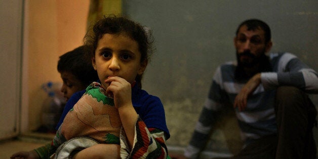 BEIRUT, LEBANON - NOVEMBER 09: Six-year-old Gazal pauses in a home she shares with 14 other Syrian refugees in a poor neighborhood with a high concentration of Syrian refugees on November 9, 2013 in Beirut, Lebanon. According to the U.N. agency responsible for the Syrian refugees in Lebanon, 812,000 Syrian's displaced by the war are currently receiving assistance from the United Nations and its partners. As the war in neighboring Syria drags on for a third year, Lebanon, a country of only 4 million people, is now home to the largest number of Syrian refugees who have fled the conflict. The situation is beginning to put huge social and political strains on Lebanon as there is currently no end in sight to the war in Syria. (Photo by Spencer Platt/Getty Images)