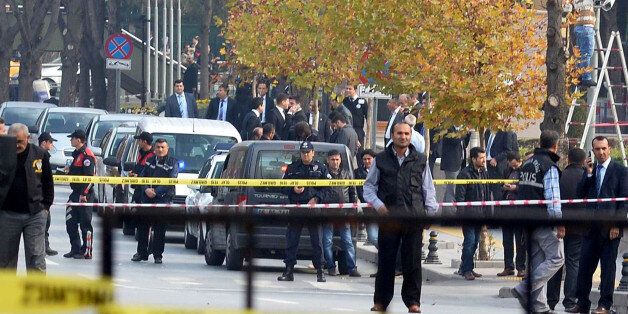 Security officials close a road leading to Turkish Prime Minister's office shortly after police subdued a man who was carrying a fake bomb in Ankara on November 21, 2031. Turkish police arrested a 'mentally unstable' man carrying a fake bomb outside the office of Prime Minister Recep Tayyip Erdogan on Thursday, officials said, causing a security scare in the capital. Local television stations had initially reported that police had shot and wounded the suspect but officials and witnesses later said they wrestled him to the ground and only fired shots in the air. AFP PHOTO /ADEM ALTAN (Photo credit should read ADEM ALTAN/AFP/Getty Images)