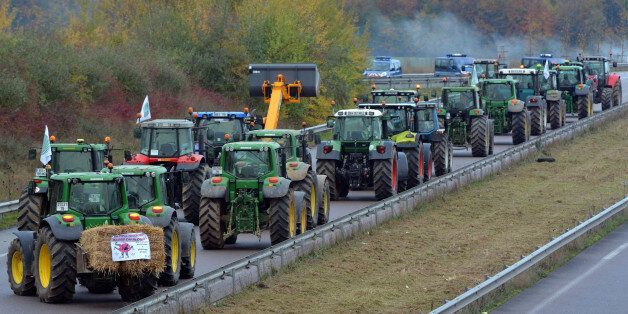PARIS, FRANCE - NOVEMBER 21: French farmers blocked highways in protest against new government taxes by pulling tractors on to the road on November 21, 2013 in Paris, France. Anti-tax protests have been staged across France in the past weeks, especially over a plan for a new levy on road freight. (Photo By Mustafa Yalcin/Anadolu Agency/Getty Images)