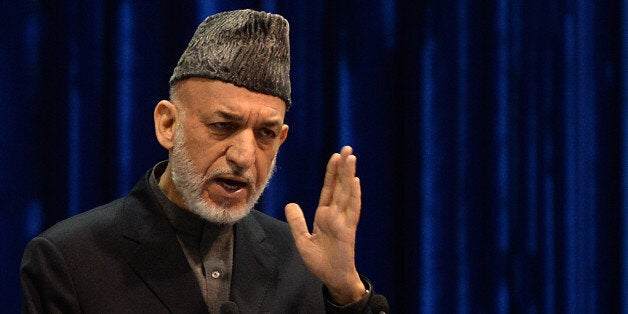 Afghan President Hamid Karzai addresses the Afghan loya jirga, a meeting of around 2,500 Afghan tribal elders and leaders, on
