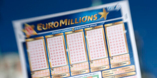 A person holds an Euromillions lottery ticket on november 14, 2012 in Nice. A lucky punter beat the French record for a Euromillions lottery today, winning a staggering 169,837,010 euros (almost $216 million), enough to buy nearly four tonnes of gold. The sole winner of the draw beats the former French record, won by a man in Calvados last year, by over seven million euros. AFP PHOTO / VALERY HACHE (Photo credit should read VALERY HACHE/AFP/Getty Images)