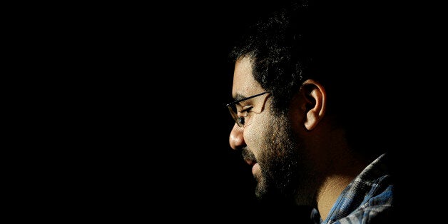 Egyptian blogger and activist Alaa Abdel Fattah gives a TV interview at his house in Cairo on December 26, 2011, a day after