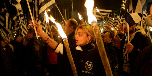 ATHENS, GREECE - NOVEMBER 30: Supporters of the ultra-nationalist party Golden Dawn demonstrate outside parliament on November 30, 2013 in Athens, Greece. The Golden Dawn supporters are demanding the release of their party leader Nikolaos Mihaloliakos and members of parliament from detention. (Photo by Milos Bicanski/Getty Images)