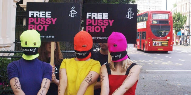 Three Amnesty International activists dressed as the Russian Band Pussy Rioters outside the Russian Embassy in London on Augu