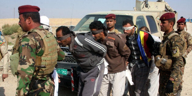 ANBAR, IRAQ OCTOBER 31 : Iraqi security guards detain 4 ISIS members on October 31,2013 in Iraq. Twenty-four Islamic State of Iraq and Syria (ISIS) an al-Qaeda affiliate, members were arrested in an operation on October 31,2013 in Anbar, Iraq. (Photo by Stringer/Anadolu Agency/Getty Images)