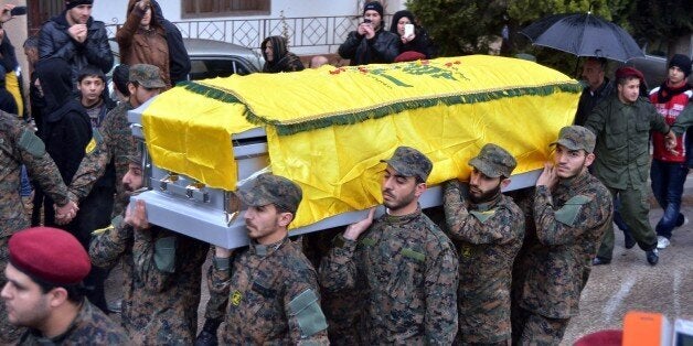 BEIRUT, LEBANON - DECEMBER 4: A funeral procession was held for a senior Hezbollah commander, Hassan al-Laqqis, gunned down outside his home in Beirut on 4 December 2013, Lebanon. (Photo by Nidal El Solh/Anadolu Agency/Getty Images)