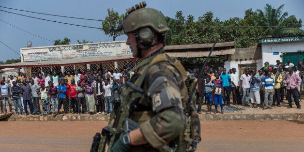 A French soldier stands guard at a checkpoint in Combattant neighborhood near Bangui's airport, on December 9, 2013. French troops on Monday began disarming fighters in the Central African Republic after a swell in sectarian violence that has claimed hundreds of lives and terrified inhabitants. AFP PHOTO / FRED DUFOUR (Photo credit should read FRED DUFOUR/AFP/Getty Images)