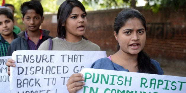 Supporters of the Communist Party of India (Marxist-Leninist) (CPI M-L) shout slogans during a demonstration against a gang rape in Muzafarnagar, in New Delhi on December 6, 2013. Over two months after the Muzaffarnagar riots, no arrests have been so far in the 13 cases of rape and sexual harassment during the violence in which over 100 people have been booked. AFP PHOTO/RAVEENDRAN (Photo credit should read RAVEENDRAN/AFP/Getty Images)