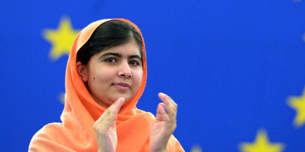 Malala Yousafzai, a Pakistani student who was shot in the head by the Pakistani Taliban applauds after being awarded with the