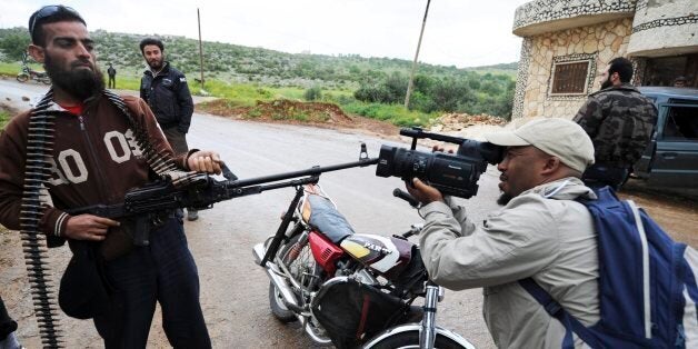 DARKOUSH, SYRIA - APRIL 16 (SOUTH AFRICA OUT):A cameraman taking footage of Free Syrian Army Soldier on April 16, 2013, in Darkoush, Syria. Al-Qauda has given its blessing to the Gift of the Givers organisation for its work in Syria. On April 14, 2013, 45 South African Medical personnel were sent to aid locals in the Darkoush hospital.(Photo by Felix Dlangamandla/Foto24/Gallo Images/Getty Images)