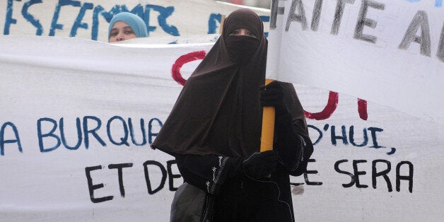 A woman wearing a 'Niqab' veil participates in a protest on February 6, 2010 in Tours, central France, after a panel of French lawmakers recommended a ban on the face-covering veil in all schools, hospitals, public transport and government offices. According to the interior ministry, only around 1,900 women wear the burqa in France, which is home to Europe's biggest Muslim minority. AFP PHOTO ALAIN JOCARD (Photo credit should read ALAIN JOCARD/AFP/Getty Images)