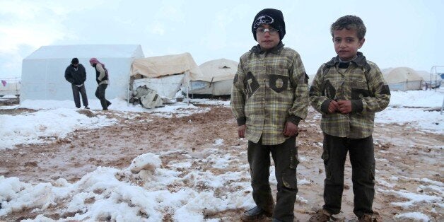 ALEPPO, SYRIA - DECEMBER 14: Syrian refugees living in a camp near Esselame Border Gate struggle to survive in harsh winter conditions in the Syrian town of Azaz, on the outskirts of Aleppo on December 14, 2013. (Photo by Veli Gurgah/Anadolu Agency/Getty Images)