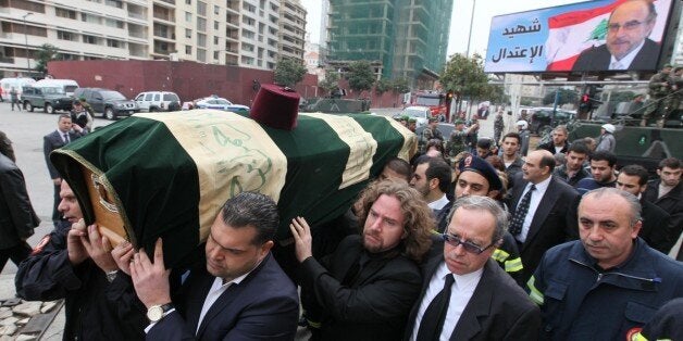 BEIRUT, LEBANON - DECEMBER 29: Lebanese people carry the coffin of former Lebanese finance minister Mohamed Chatah during his funeral ceremony on December 29, 2013 in Beirut, Lebanon. Chatah was killed in an explosion that targeted his car in Beirut, also a few meters away from where the car of Hariri was bombed a few years ago. The bombing also claimed the lives of five other people, including Chatah's bodyguard. (Photo by Ratib Al Safadi/Anadolu Agency/Getty Images)