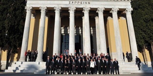 EU commissioners and Greek officials pose for a family photo outside the Zappeion Hall in Athens on January 8, 2014, as Greec
