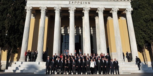 EU commissioners and Greek officials pose for a family photo outside the Zappeion Hall in Athens on January 8, 2014, as Greece takes over the rotating European Union presidency for six months. Europe's political elite mustered in Athens on Wednesday as troubled Greece officially took over the helm of the EU presidency for a six-month term leading to crucial bloc-wide parliamentary elections. AFP PHOTO / LOUISA GOULIAMAKI (Photo credit should read LOUISA GOULIAMAKI/AFP/Getty Images)