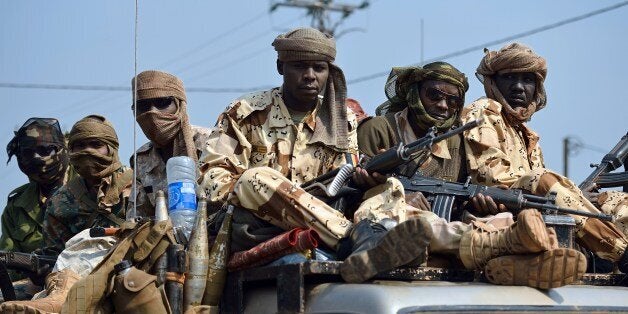 Chadian troops of the African-led International Support Mission to the Central African Republic (MISCA) patrol following the resignation of the Central African Republic president in Bangui on January 10, 2014. Michel Djotodia stepped down under regional pressure after failing to stem sectarian violence ripping his country apart. His resignation sparked an immediate eruption of joy in the capital Bangui, with many residents expressing hope the violence would now subside. AFP PHOTO/ERIC FEFERBERG (Photo credit should read ERIC FEFERBERG/AFP/Getty Images)