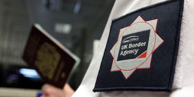 File photo dated 23/11/2009 of a UK Border Agency officer checking a passport. More than three-quarters of British people want to see a cut in immigration, a survey of social attitudes has revealed.