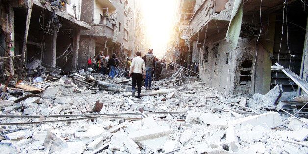 DAMASCUS, SYRIA - JANUARY 17: Syrians in Damascus gathering to protests both the barrel bomb attacks and the situation of the Yarmouk refugee camp on January 17, 2014. (Photo by Stringer/Anadolu Agency/Getty Images)