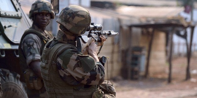 A French soldier part of the Sangaris operation forces aims rifle during a patrol at the 'Reconciliation crossroad' as unidentified shotguns fired in the area after the announcement of the resignation of Central African Republic President. Michel Djotodia stepped down under regional pressure after failing to stem sectarian violence ripping his country apart. Regional leaders, who had piled pressure on Djotodia to step down during their summit in Chad, called it a 'highly patriotic decision' to wrest the country out of paralysis, while France urged transition authorities to decide swiftly on a new caretaker president. AFP PHOTO ERIC FEFERBERG (Photo credit should read ERIC FEFERBERG/AFP/Getty Images)