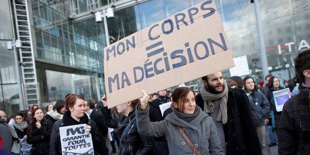 A women holds a placard reading 'My body = My decision' as she demonstrates to defend abortion rights in Paris on January 19, 2014. Between 200 and 300 people gathered in Paris to defend abortion rights in reaction to an anti-abortion protest taking place a few kilometres away, and to protest in solidarity with Spanish women against their government's announcement of December 20, 2013 that it would roll back a 2010 law that had allowed women to opt freely for abortion in the first 14 weeks of pregnancy. AFP PHOTO / THOMAS SAMSON (Photo credit should read THOMAS SAMSON/AFP/Getty Images)