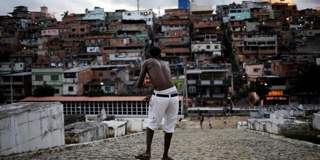 A man flies his kite in a cemetery in the Vila Operaria Favela of Rio de Janeiro, Brazil, June 26, 2016. REUTERS/Nacho Doce SEARCH "RIO KITES" FOR THIS STORY. SEARCH "THE WIDER IMAGE" FOR ALL STORIES