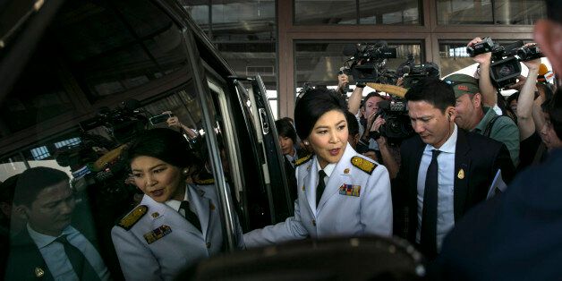 BANGKOK, THAILAND - JANUARY 28: Thai caretaker Prime Minister Yingluck Shinawatra leaves a cabinet meeting after deciding to go forward with the general elections on January 28, 2014 in Bangkok, Thailand. The government met today to push forward with the February 2nd general elections. The advance polling in the capital city was blocked by the anti-government protesters on Sunday. Bangkok Shutdown has been in effect for over two weeks as the anti-government protesters continue to block major intersections. The Thai government imposed a 60-day state of emergency in Bangkok and the surrounding provinces in an attempt to cope with the on-going political turmoil but so far this decree has had no effect on the mass protests.(Photo by Paula Bronstein/Getty Images)