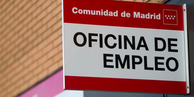 An 'Oficina de Empleo' sign hangs outside the entrance to an employment office in Madrid, Spain, on Wednesday, April 3, 2013. Spain's government is waiting for the result of negotiations with the European Union on its budget deficit goals before deciding on its tax policy for 2014. Photographer: Angel Navarrete/Bloomberg via Getty Images
