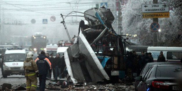 Russian firefighters and security personnel inspect the destroyed trolleybus in Volgograd on December 30, 2013. Ten people were killed in a bombing that destroyed a packed trolleybus in the southern Russian city of Volgograd, the second attack in the city in two days after a suicide strike on its main train station, officials said. AFP PHOTO (Photo credit should read STRINGER/AFP/Getty Images)