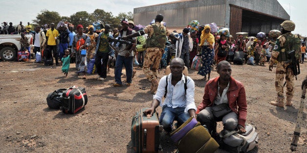 Chadian nationals and other foreign civilians, mostly Muslims, wait with their belongings to be evacuated to N'Djamena as they flee Bangui to avoid being targeted by Anti-Balaka Christian militants on January 31, 2014. Fighting in Bangui has killed at least 30 people over the past three days, the International Committee of the Red Cross said. Thirty bodies have been collected from the streets of Bangui, the head of the ICRC delegation Georgios Georgantas said, adding that he was very concerned by the 'unprecedented level of violence' that has also left at least 60 people wounded. AFP PHOTO/ ISSOUF SANOGO (Photo credit should read ISSOUF SANOGO/AFP/Getty Images)