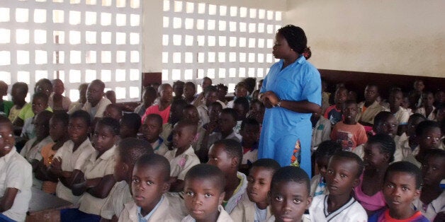 TO GO WITH AFP STORY BY LAUDES MARTIAL BON
Congolese teacher Gloire Louzolo speaks to pupils in a classroom of the Itsali sc