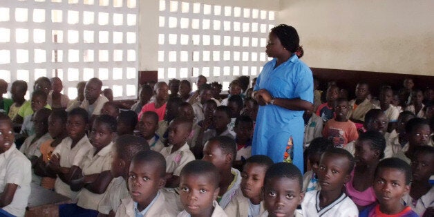 TO GO WITH AFP STORY BY LAUDES MARTIAL BONCongolese teacher Gloire Louzolo speaks to pupils in a classroom of the Itsali school on June 14, 2013 in Brazzaville. AFP PHOTO / LAUDES MARTIAL MBON (Photo credit should read Laudes Martial Mbon/AFP/Getty Images)