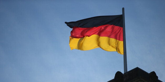 BERLIN, GERMANY - DECEMBER 16: A German flag flies over the Reichstag on the day Angela Merkel, Chancellor and Chairwoman of the German Christian Democrats (CDU), Horst Seehofer, Chairman of the Bavarian Christian Democrats (CSU) and Sigmar Gabriel, Chairman of the German Social Democrats (SPD), are scheduled to sign the coalition agreement between the three parties that seals their cooperation and allows the creation of a new German coalition government on December 16, 2013 in Berlin, Germany. The new government is scheduled to be sworn in tomorrow. (Photo by Sean Gallup/Getty Images)